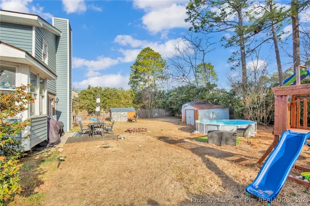 a view of a backyard with sitting area