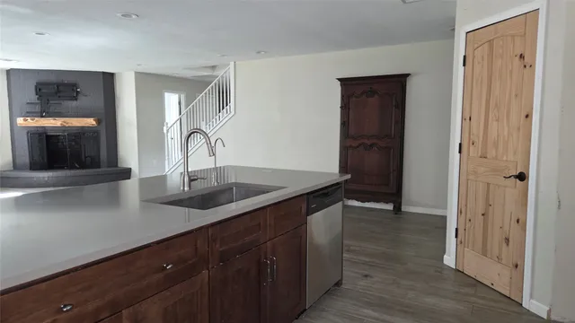 a kitchen with a sink and a refrigerator