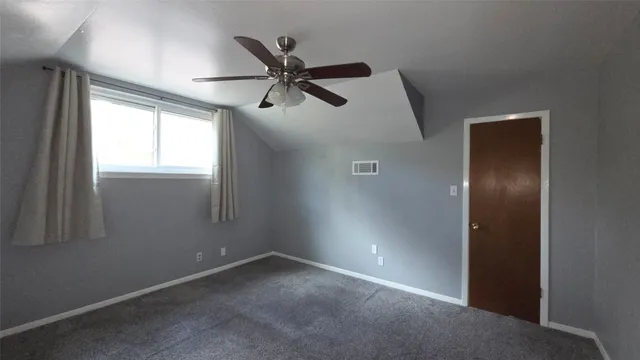 an empty room with windows and entrance