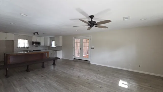a view of work space with wooden floor and a window