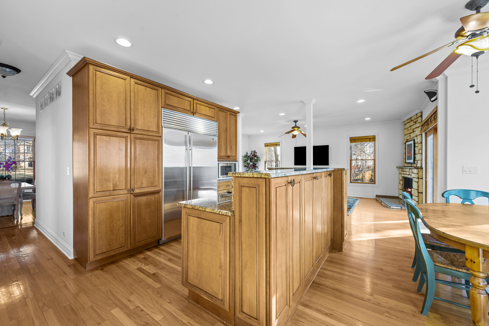 516 Drexel Avenue Glencoe, IL 60022 - Photo 11 of 32 a kitchen with stainless steel appliances granite countertop a refrigerator a oven a sink with island and chairs with wooden floor