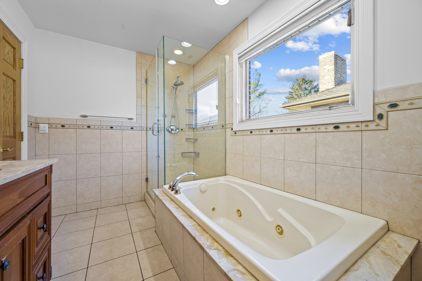 516 Drexel Avenue Glencoe, IL 60022 - Photo 16 of 32 a bathroom with a tub a sink and glass door