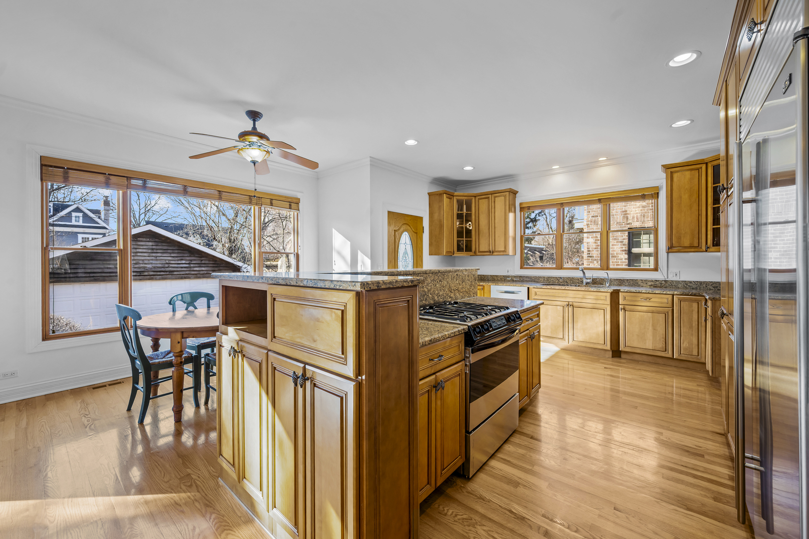 516 Drexel Avenue Glencoe, IL 60022 - Photo 9 of 32 a kitchen with granite countertop a stove a sink a dining table and chairs