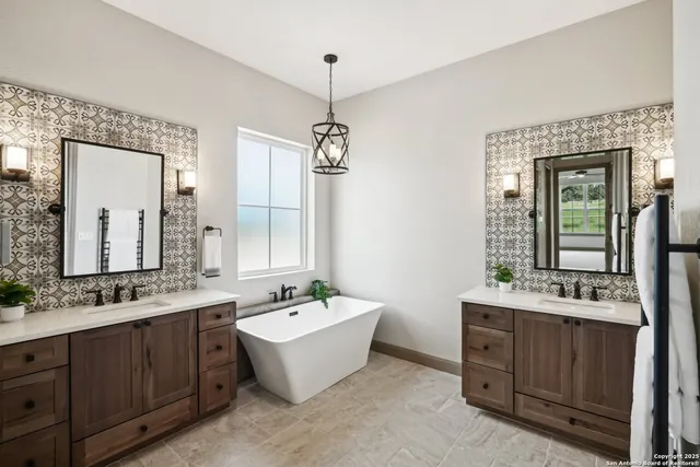 a spacious bathroom with a double vanity sink double mirror and bathtub