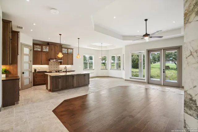 a large room with a large window and stainless steel appliances