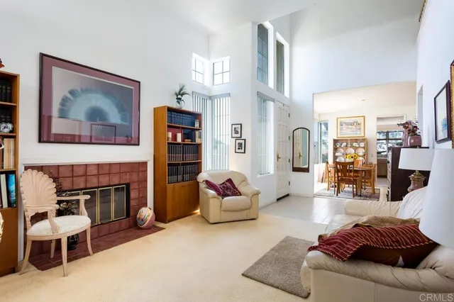 a living room with furniture fireplace and a window