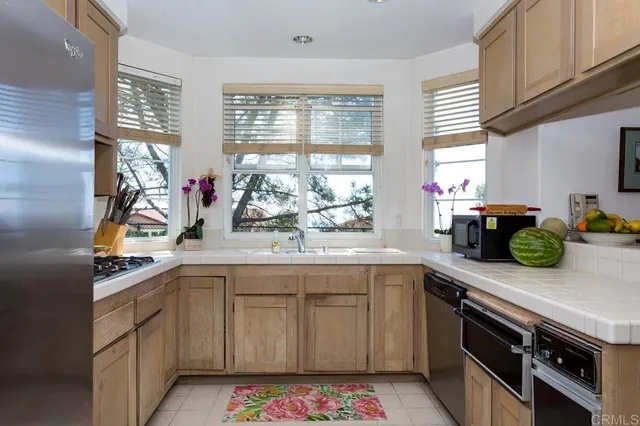 a kitchen with a sink stove and cabinets
