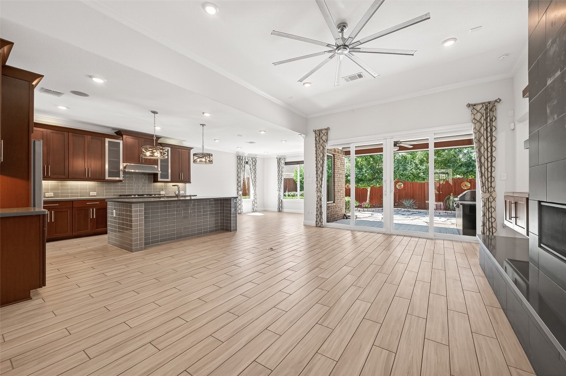 51 Scepter Ridge Sugar Land, TX 77498 - Photo 17 of 46 a large kitchen with stainless steel appliances granite countertop a stove top oven a sink dishwasher a dining table and chairs with wooden floor