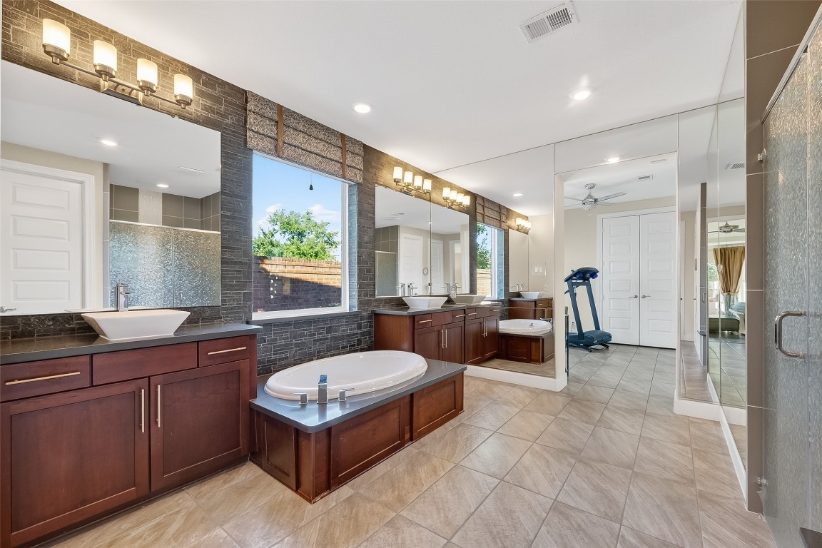 51 Scepter Ridge Sugar Land, TX 77498 - Photo 28 of 46 a spacious bathroom with a double vanity sink a mirror and a bathtub