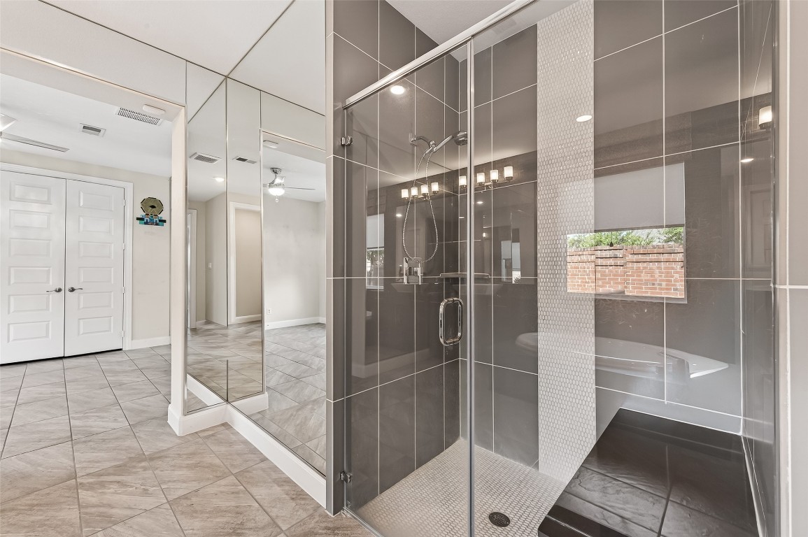 51 Scepter Ridge Sugar Land, TX 77498 - Photo 30 of 46 a bathroom with a glass shower door and a glass door shower