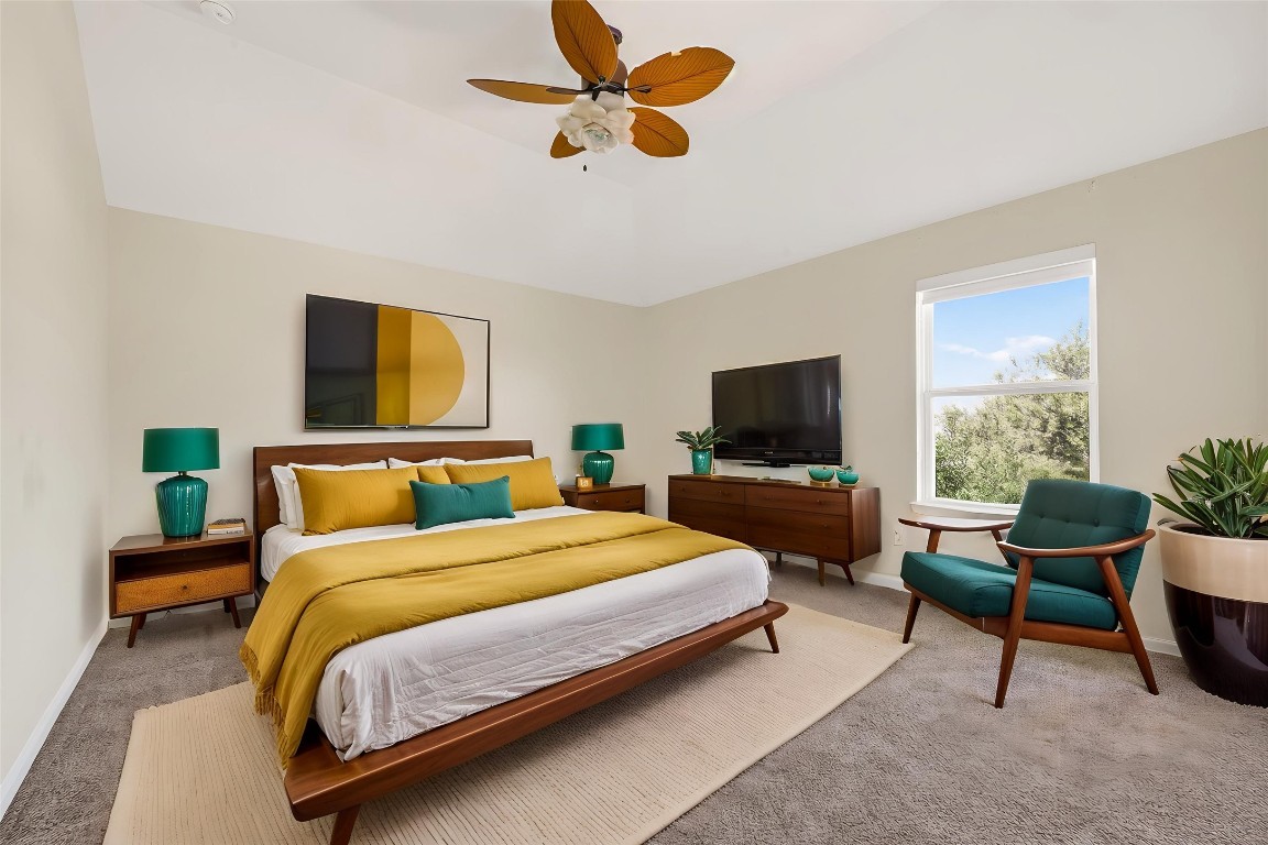 51 Scepter Ridge Sugar Land, TX 77498 - Photo 38 of 46 a bedroom with a bed a couch and a flat screen tv