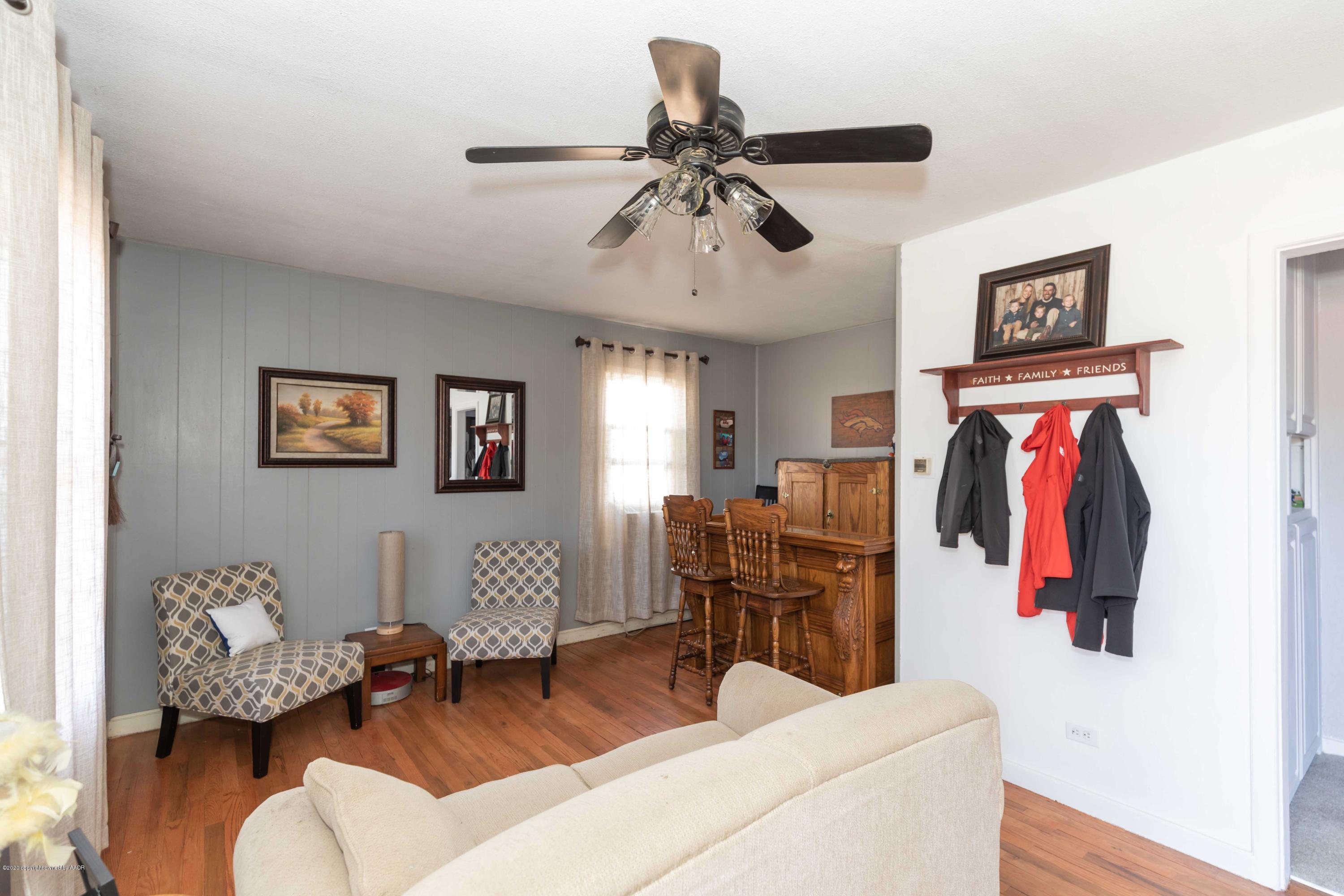 3623 South Hayden Street Amarillo, TX 79110 - Photo 4 of 28 a living room with furniture and a chandelier