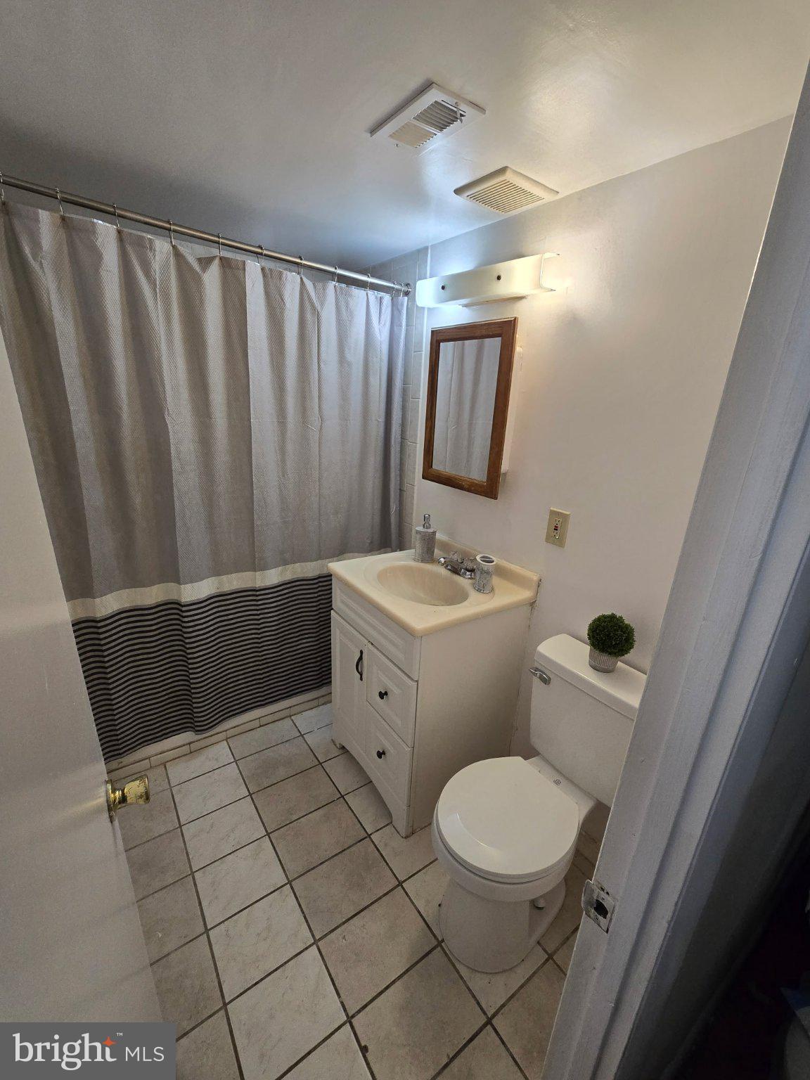 3384 Hewitt Avenue, Unit 201 Silver Spring, MD 20906 - Photo 9 of 10 a bathroom with a toilet a sink and mirror