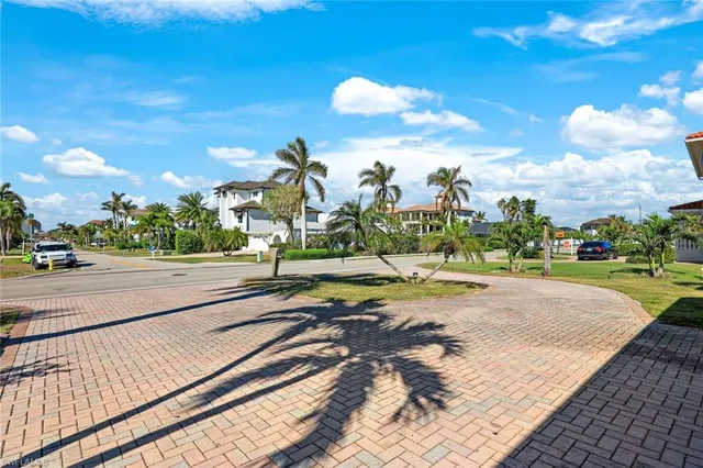 a spacious bedroom with two beds and a chandelier