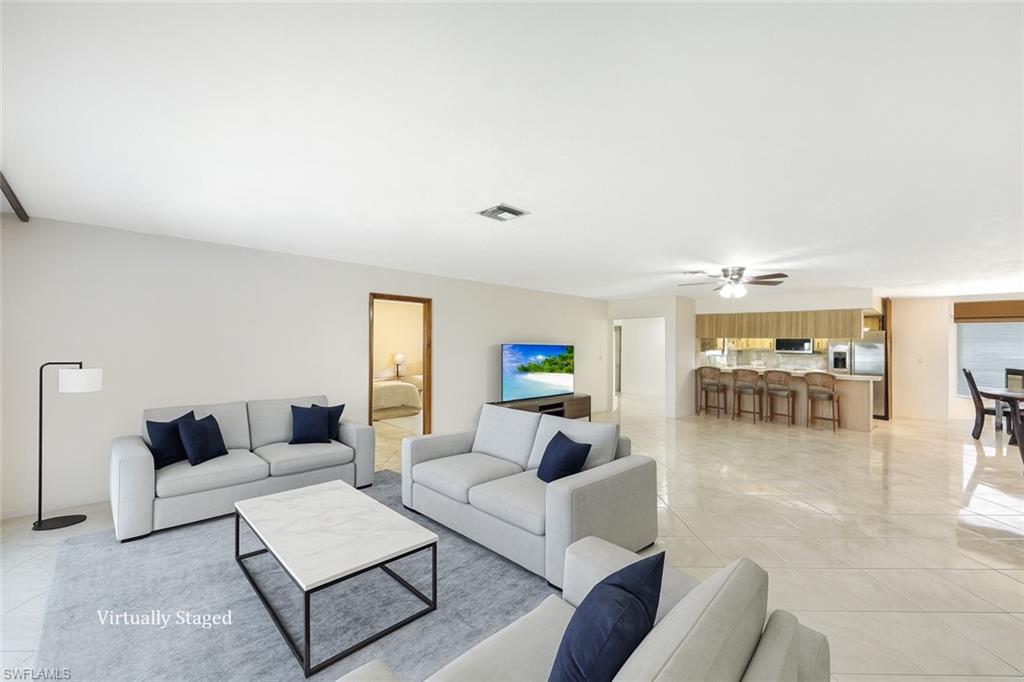 9940 Vanderbilt Drive Naples, FL 34108 - Photo 2 of 14 a living room with furniture and a table