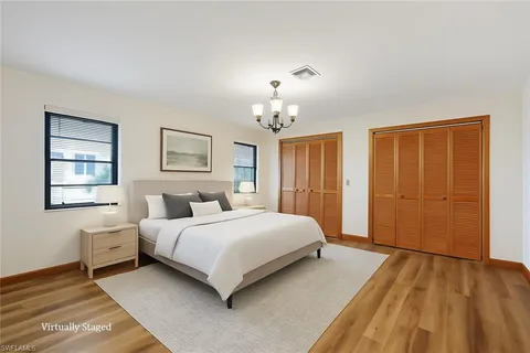 a spacious bedroom with a bed and a window