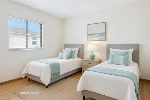 a bedroom with two beds and a window