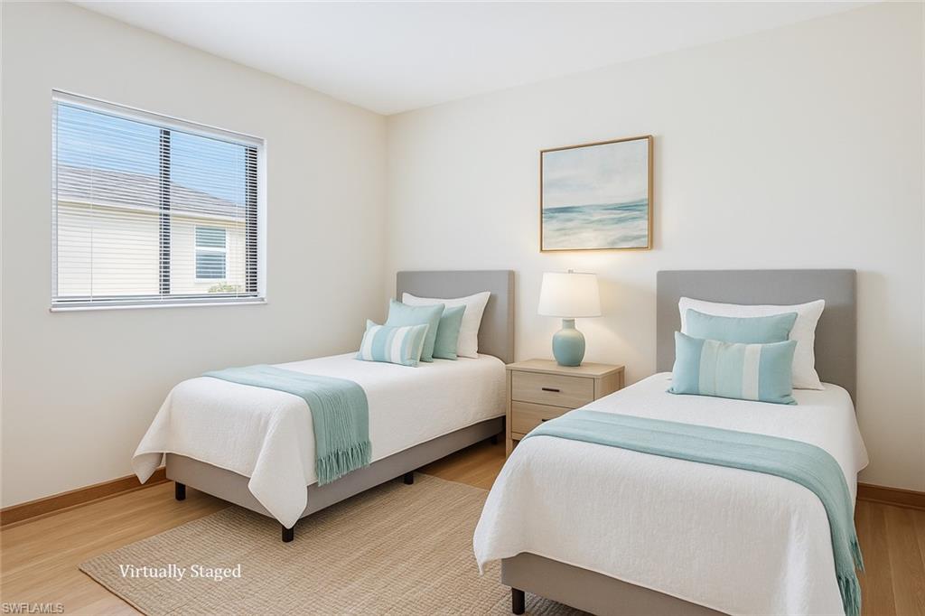 9940 Vanderbilt Drive Naples, FL 34108 - Photo 4 of 14 a bedroom with two beds and a window