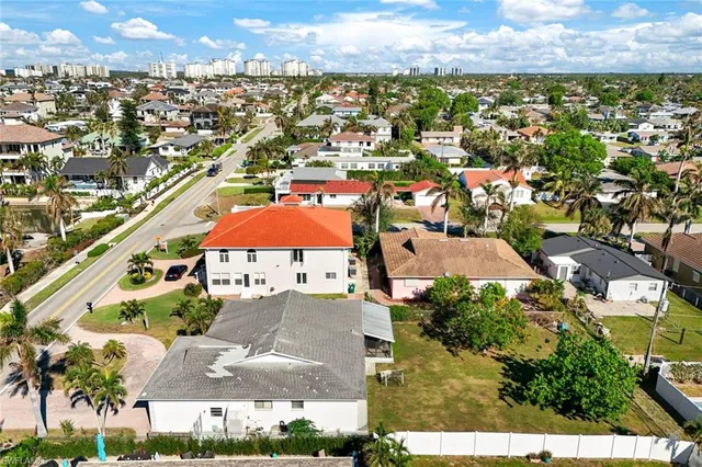 a view of a city with lawn chairs and large tree