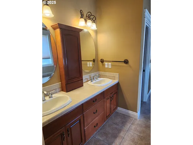 a bathroom with a double vanity sink and mirror