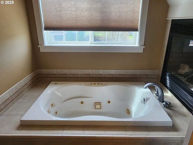 a view of an empty room with cabinet and mirror