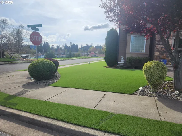a view of a house with a yard and a garden