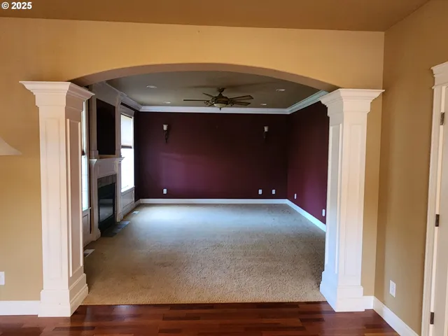 a view of an empty room with a fireplace