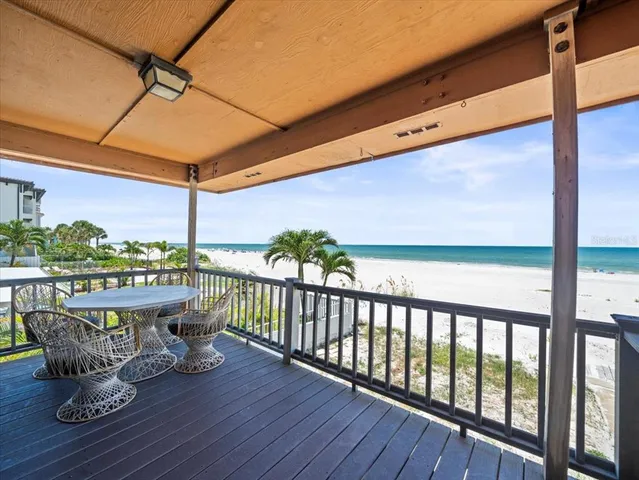a view of a swimming pool with a yard and outdoor seating