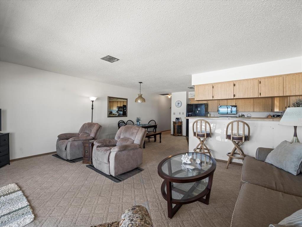 18218 Sunset Boulevard, Unit A St. Petersburg, FL 33708 - Photo 32 of 48 a living room with furniture and a table