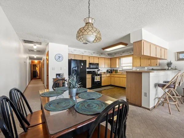 a kitchen with a sink a stove top oven and cabinets