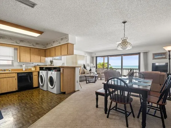 a kitchen with a refrigerator and a stove top oven