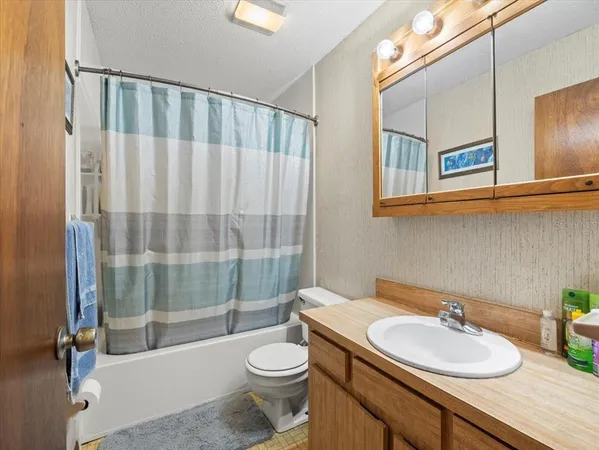 a bathroom with a double vanity sink toilet and shower