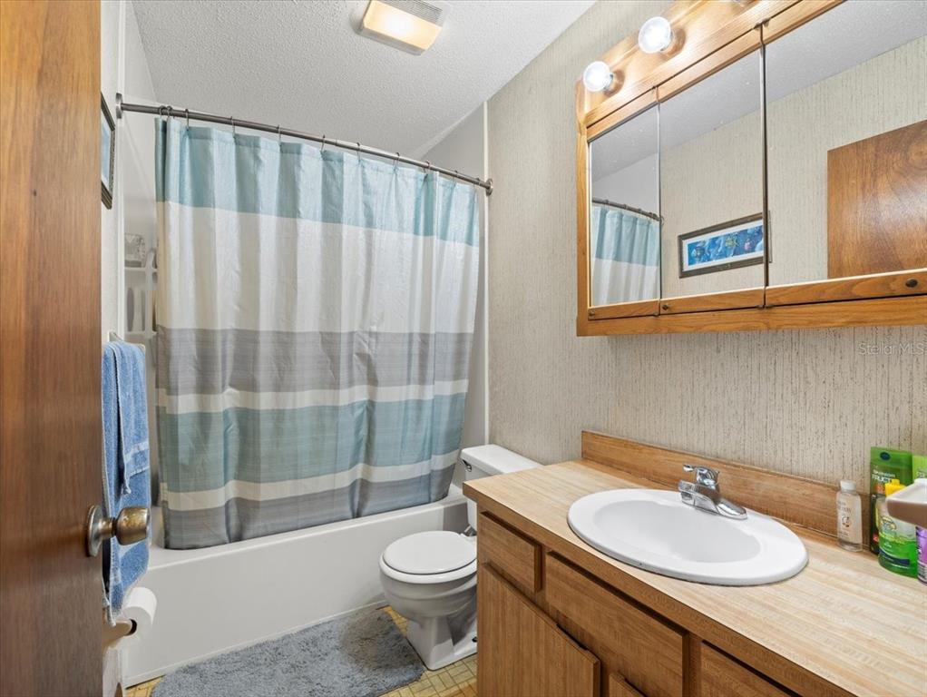 18218 Sunset Boulevard, Unit A St. Petersburg, FL 33708 - Photo 41 of 48 a bathroom with a sink a toilet and a bathtub