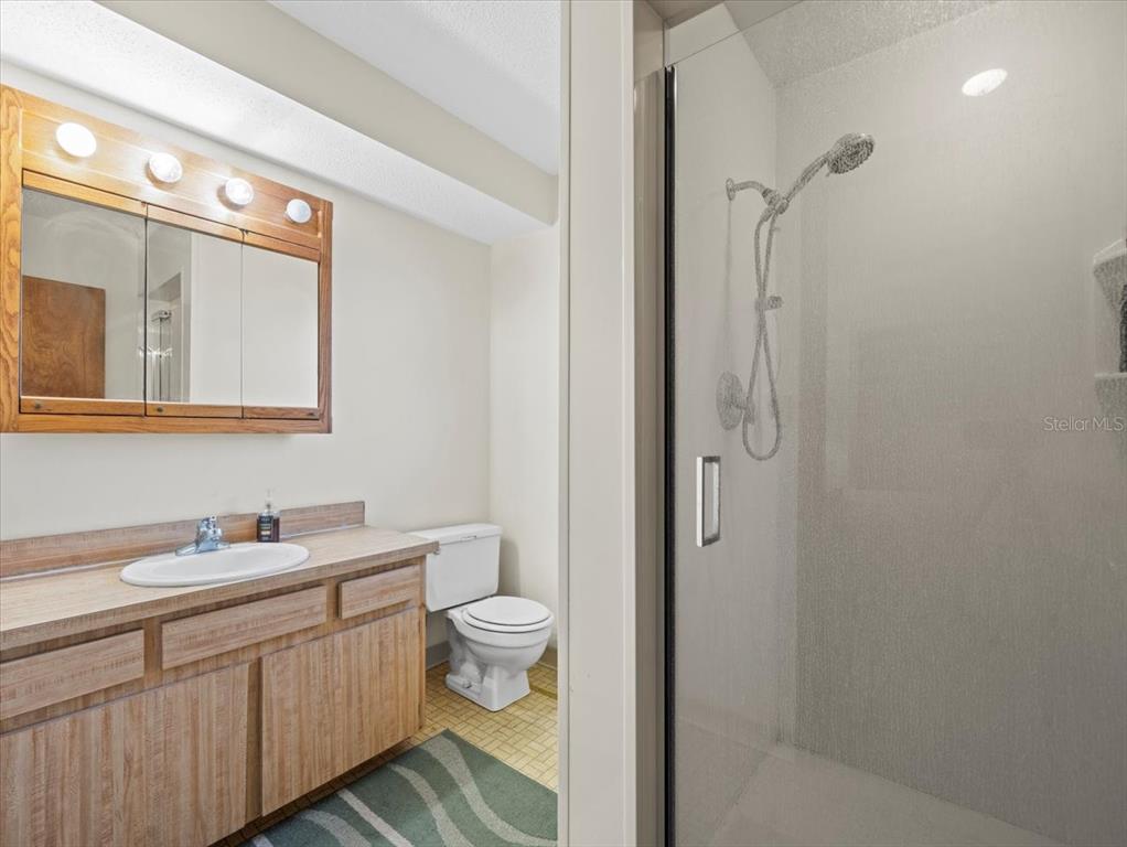 18218 Sunset Boulevard, Unit A St. Petersburg, FL 33708 - Photo 44 of 48 a bathroom with a double vanity sink toilet and shower
