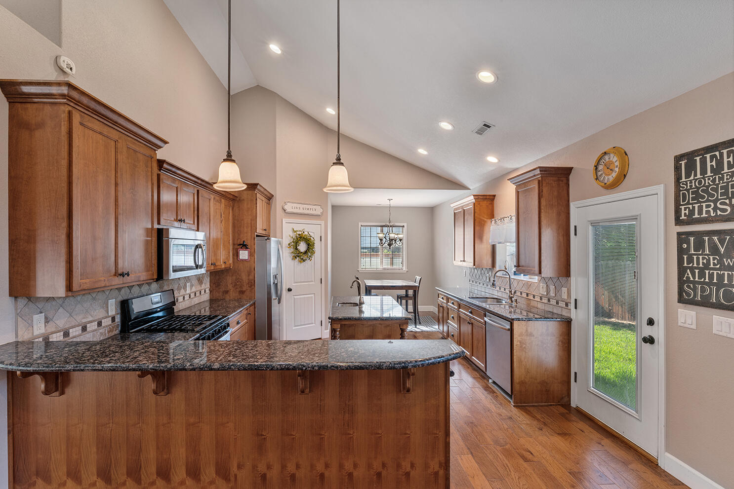 72 Pineridge Lane Eagle Point, OR 97524 - Photo 11 of 34 a large kitchen with granite countertop a large counter top space a sink stainless steel appliances and cabinets