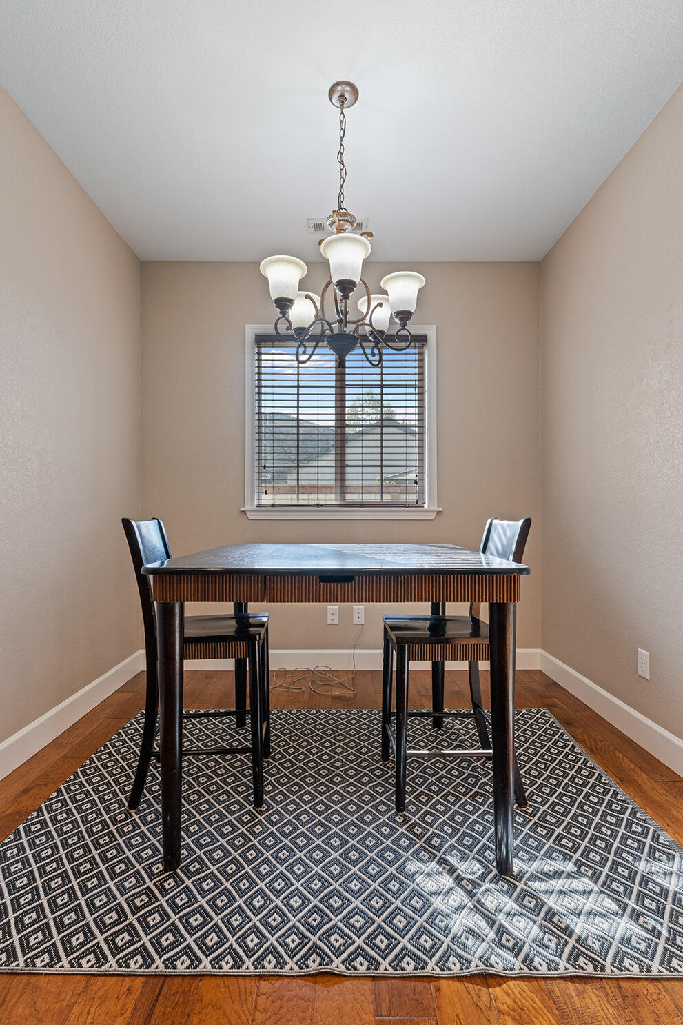 72 Pineridge Lane Eagle Point, OR 97524 - Photo 16 of 34 a dining room with wooden floor a chandelier and wooden floor