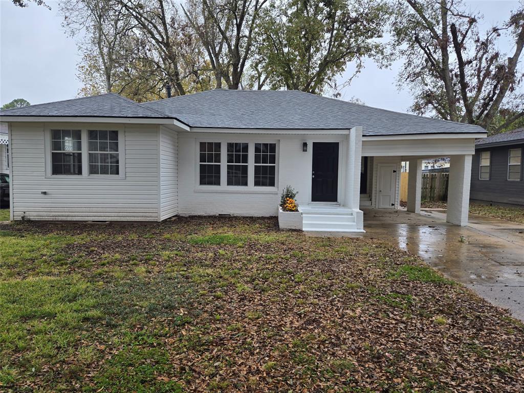 233 Roma Drive Shreveport, LA 71105 - Photo 1 of 12 View of front of home featuring a porch, an attached carport, concrete driveway, a shingled roof, and a front yard