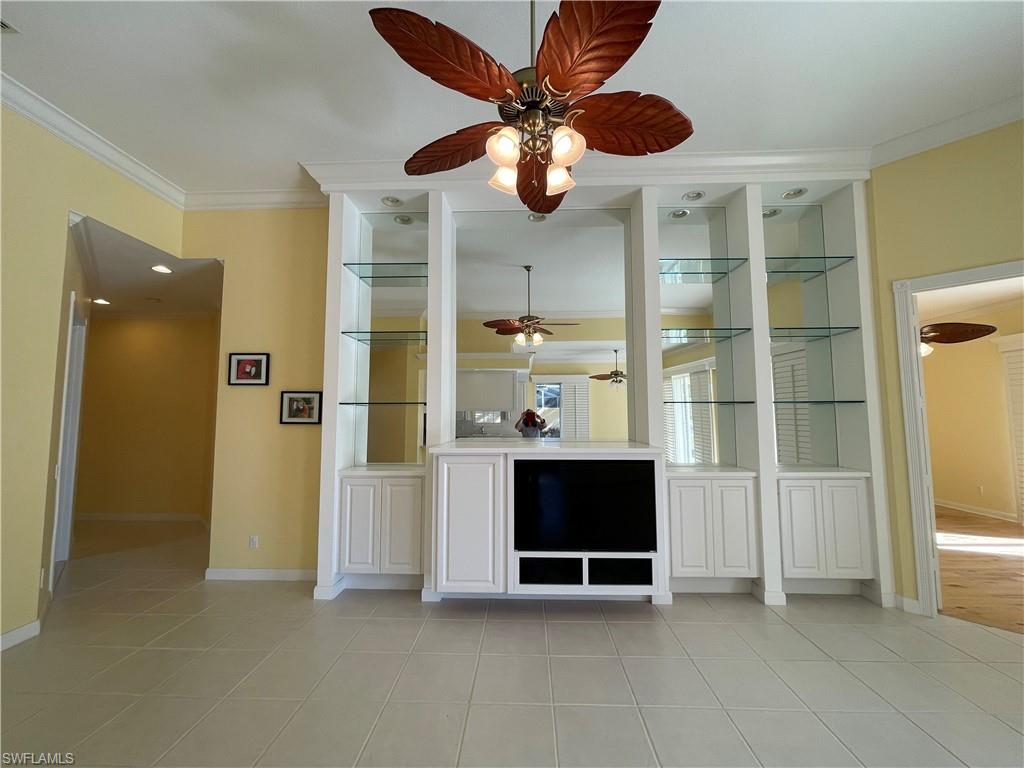 7304 Carducci Court Naples, FL 34114 - Photo 13 of 40 a view of an empty room with a ceiling fan and entryway