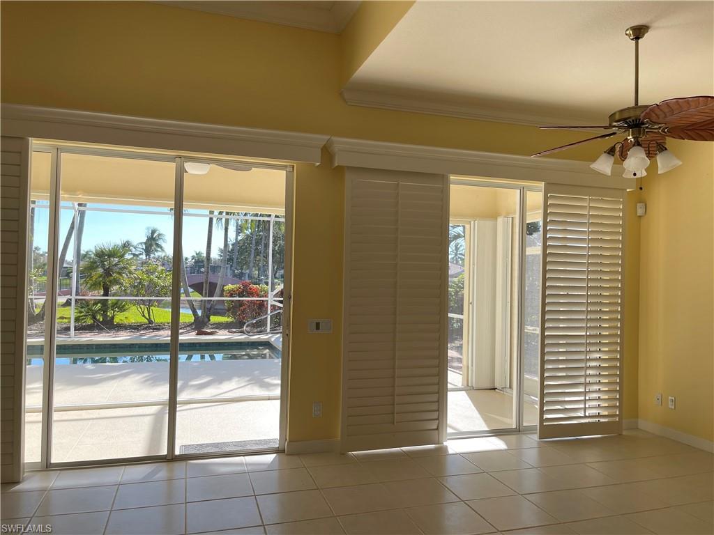 7304 Carducci Court Naples, FL 34114 - Photo 15 of 40 a view of a hallway with a glass door