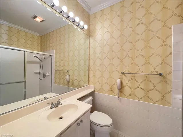 a bathroom with a sink mirror and toilet