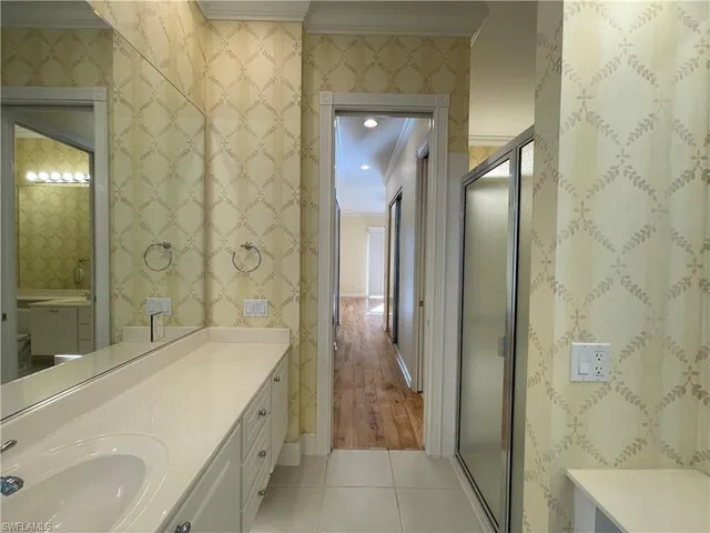 a bathroom with a granite countertop sink a toilet and shower