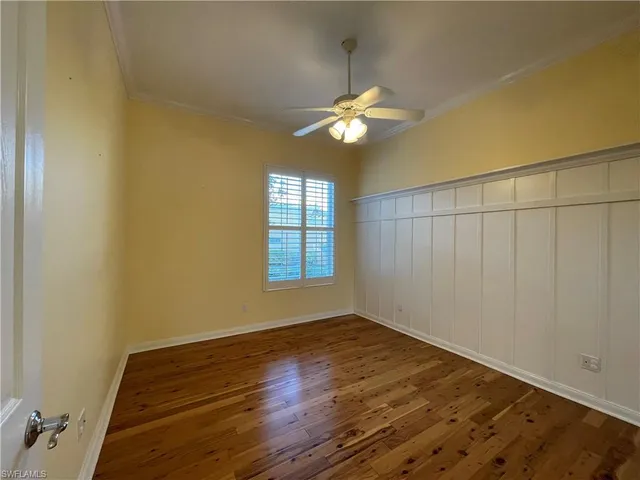 a view of a room with wooden floor and a window