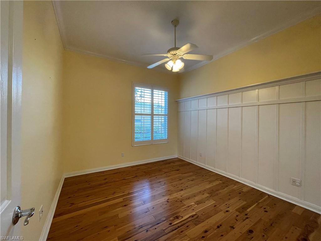 7304 Carducci Court Naples, FL 34114 - Photo 21 of 40 a view of a room with wooden floor and a window