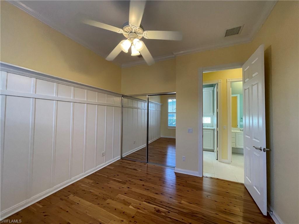 7304 Carducci Court Naples, FL 34114 - Photo 22 of 40 a view of an empty room with wooden floor