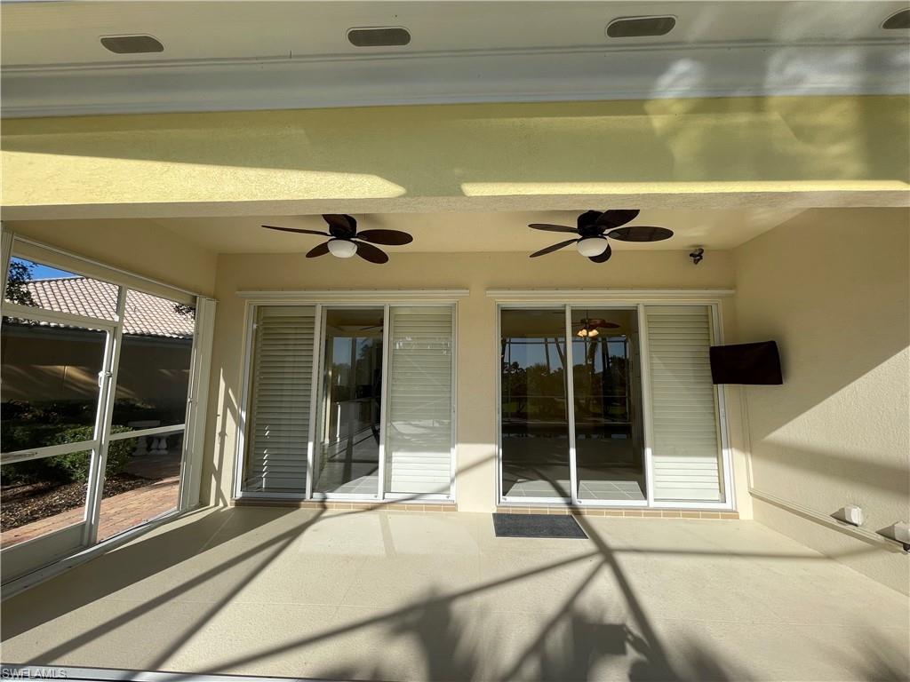 7304 Carducci Court Naples, FL 34114 - Photo 25 of 40 a view of a building with a large window and door