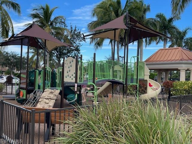 7304 Carducci Court Naples, FL 34114 - Photo 33 of 40 a view of a table and chairs under an umbrella in patio