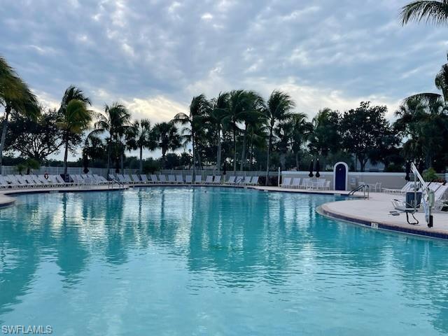 7304 Carducci Court Naples, FL 34114 - Photo 39 of 40 a view of swimming pool with outdoor seating and yard in back