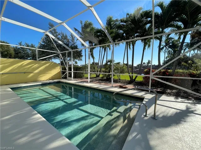 a view of swimming pool with a patio and a yard