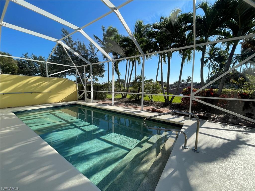 7304 Carducci Court Naples, FL 34114 - Photo 5 of 40 a view of swimming pool with a patio and a yard