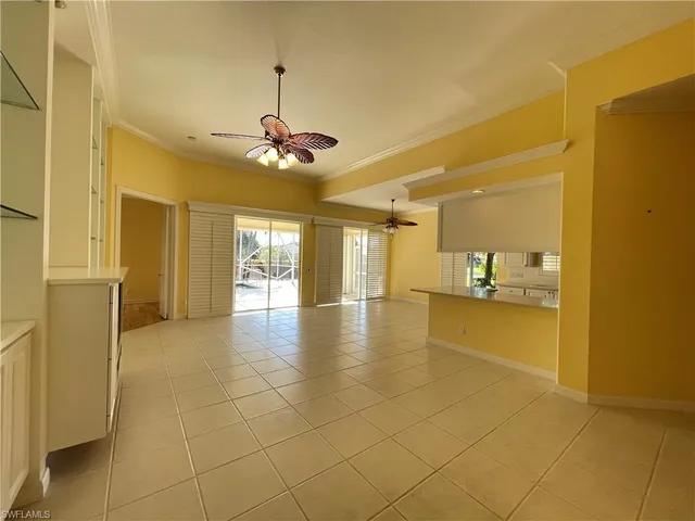 a view of a livingroom with a furniture chandelier fan and windows